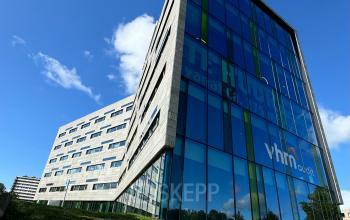 Exterior view of office building at Zwartewaterallee 56, Zwolle, Zwolle with large glass windows and green lawn.