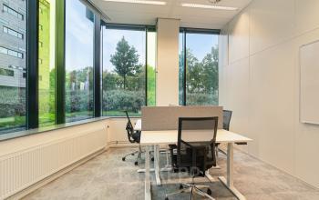 Bright office with large windows and modern chairs at Zwartewaterallee 56, Zwolle, perfect for office space rental.