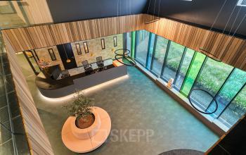 Modern office reception area with sleek design and natural light at Zwartewaterallee 56, Zwolle, ideal for office space rental.