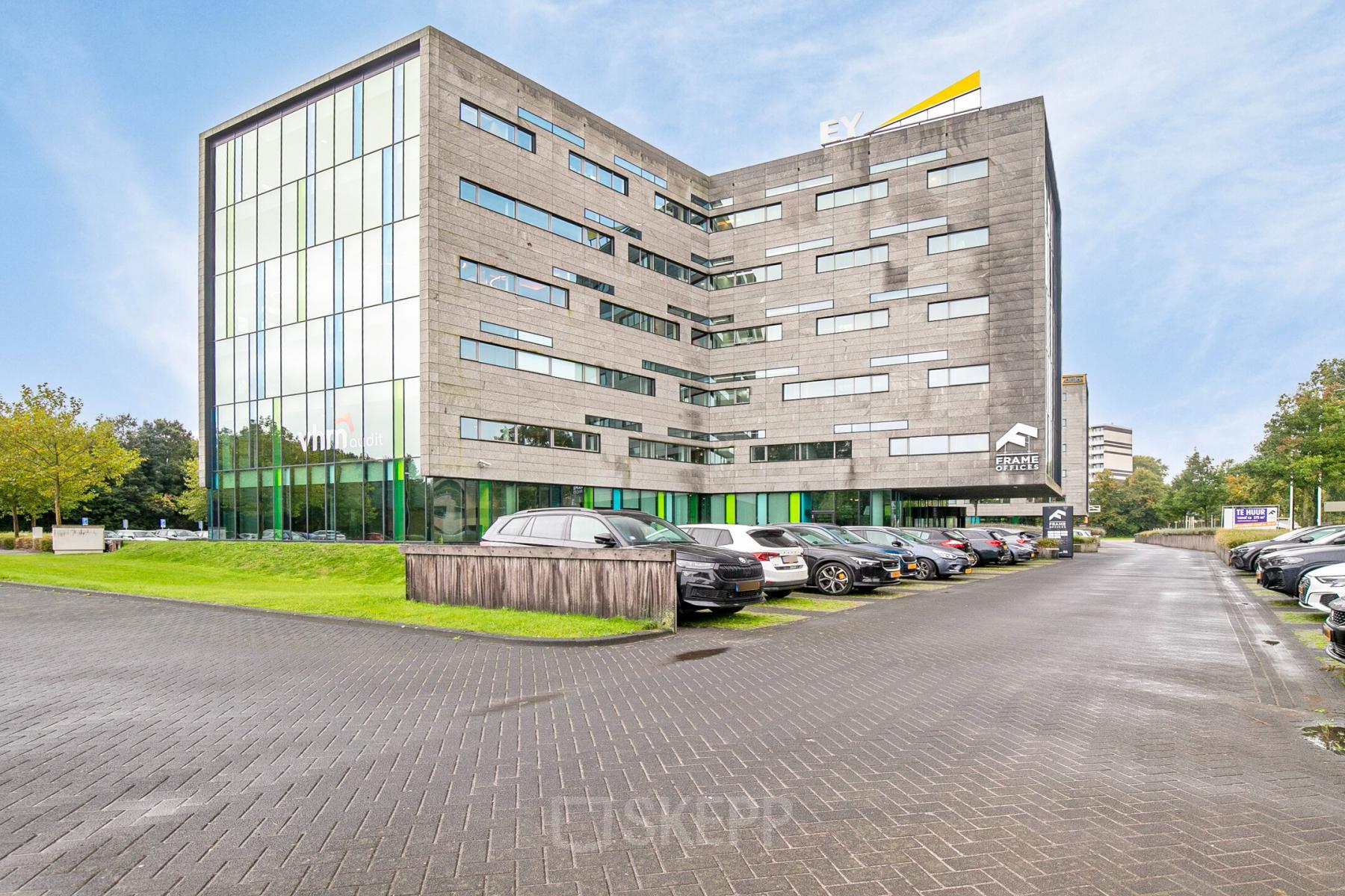 Exterior view of Zwartewaterallee 56 in Zwolle, featuring a modern office building with ample parking space. Ideal for office space rental.