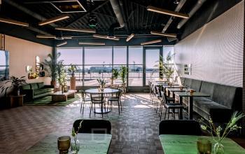 Bright, modern workspace in Zwolle with stylish furniture and large windows letting in natural light, ideal for office space rental.