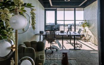 Modern furnished office space at Ceintuurbaan 28, Zwolle, featuring large windows, desks, chairs, and plants, perfect for rent office space seekers.