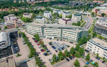 Aerial view of office buildings at Dokter van Deenweg 1 in Zwolle with a spacious parking area. Ideal location for office space rental.
