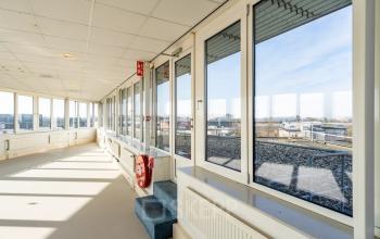 Bright office hall with large windows and city view, ideal for office space rental in Zwolle.