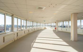 Spacious interior at Dokter van Deenweg 1, Zwolle, perfect for office space rental with large windows offering ample natural light.
