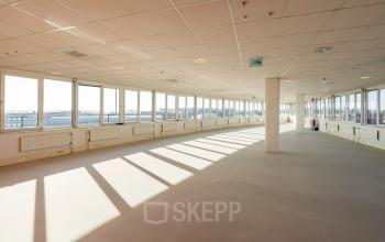 Spacious office space for rent on Dokter van Deenweg 1, Zwolle, featuring large windows allowing natural light.